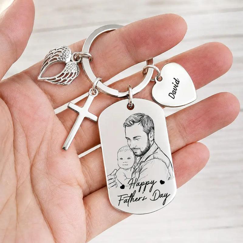 Hand holding a personalized father portrait keychain with decorative charms