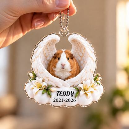 Hand holding a spaniel memorial ornament with angel wings