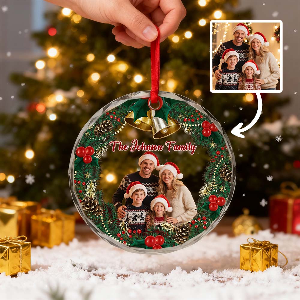 Hand holding a family photo Christmas ornament beside its source photo