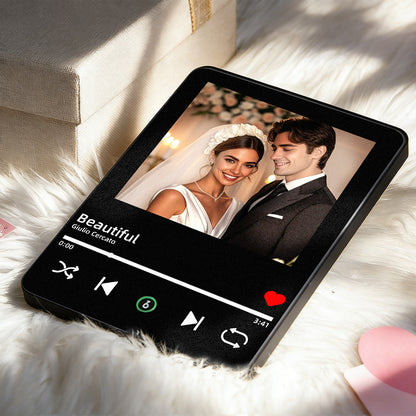 Black music photo frame with couple portrait displayed on soft fabric