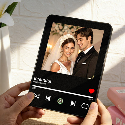 Hands holding a custom wedding photo music frame