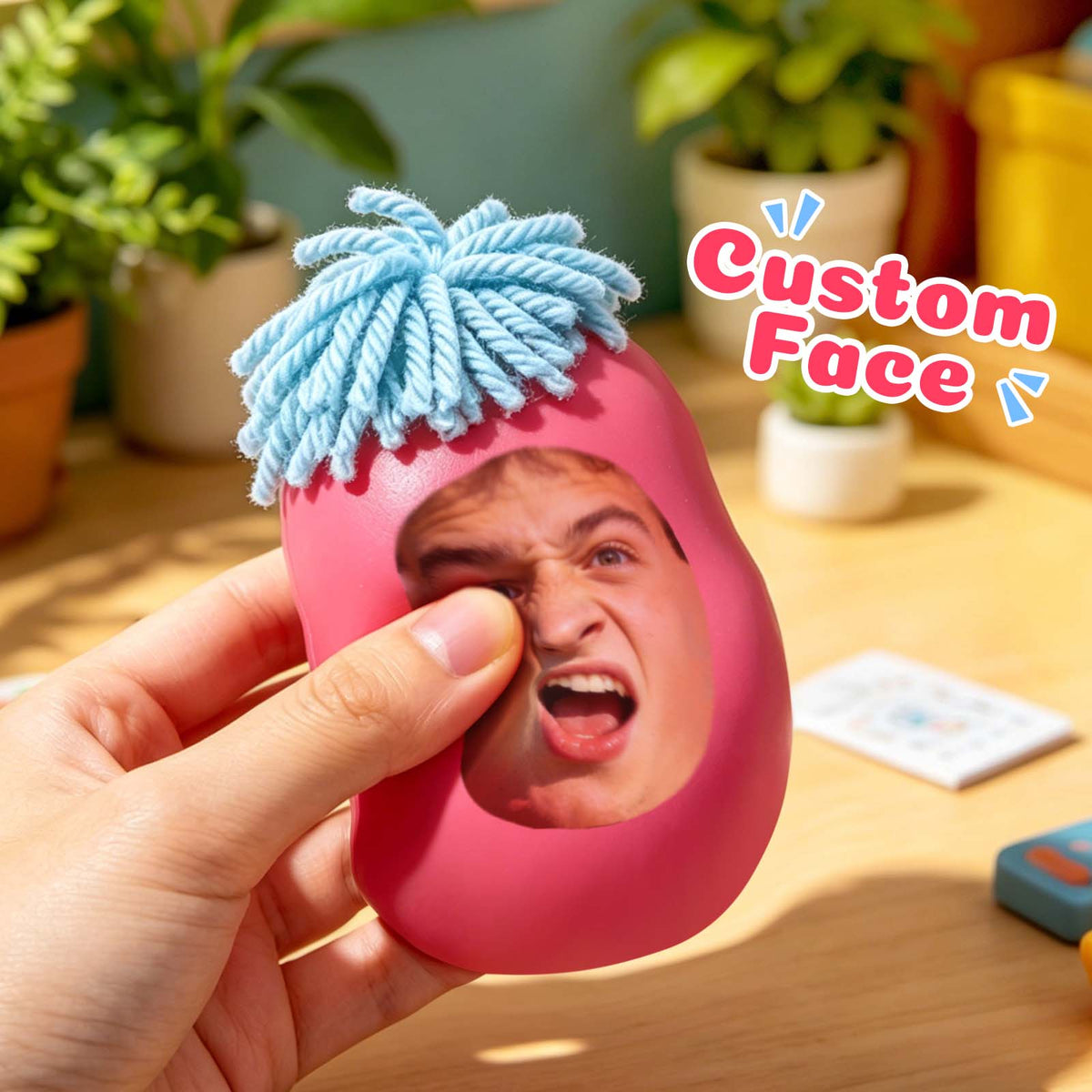 Pink custom face squishy toy being squeezed