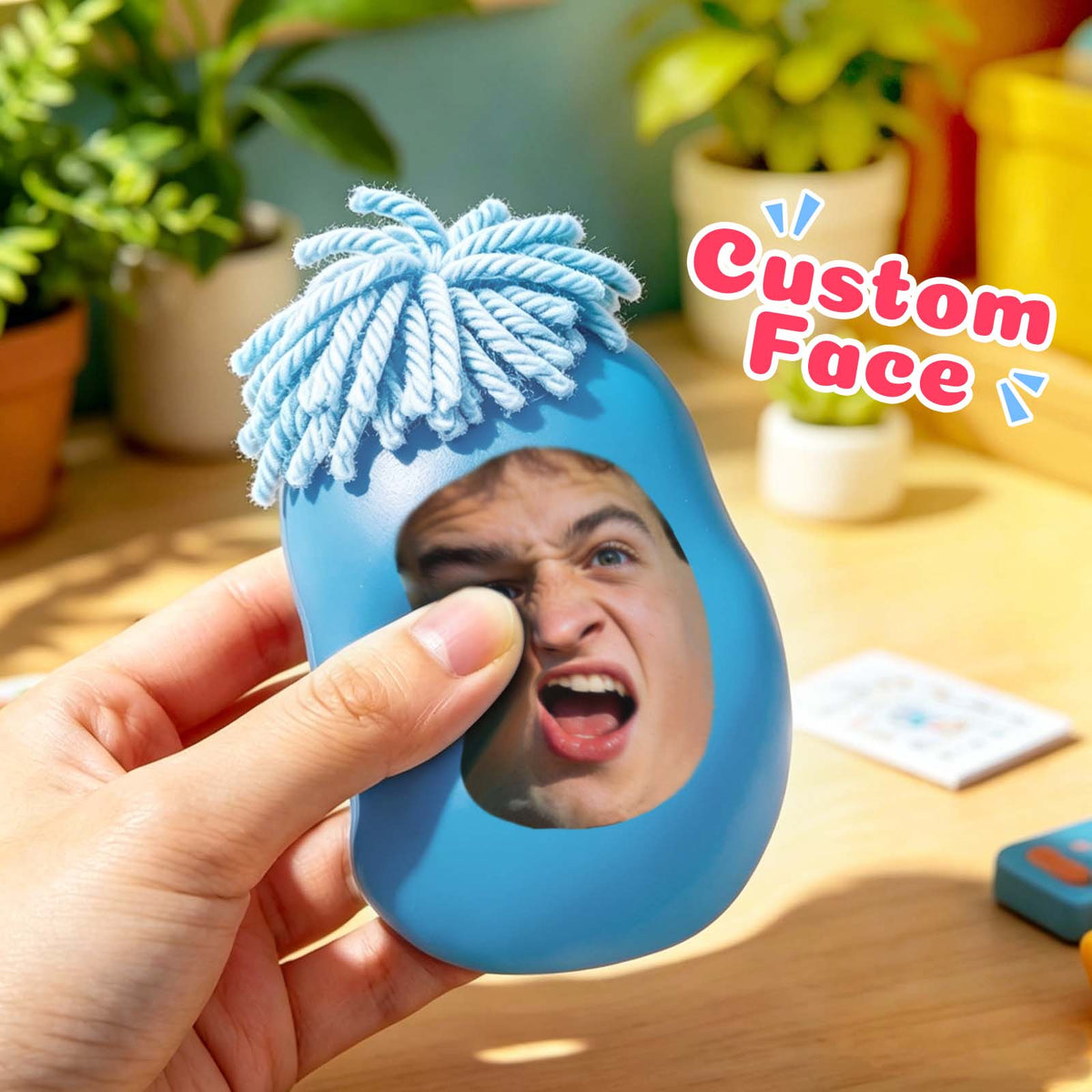 Blue personalized photo face squishy toy shown in hand
