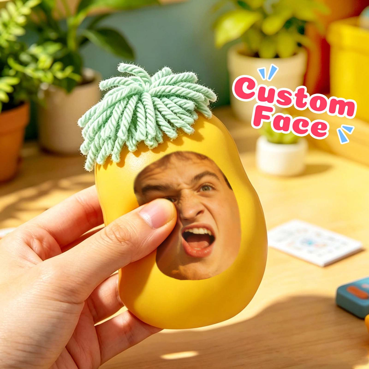 Yellow personalized face squishy toy being squeezed