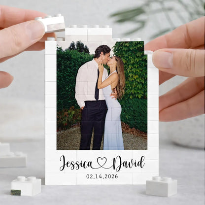 Hands assembling a personalized wedding photo building block frame